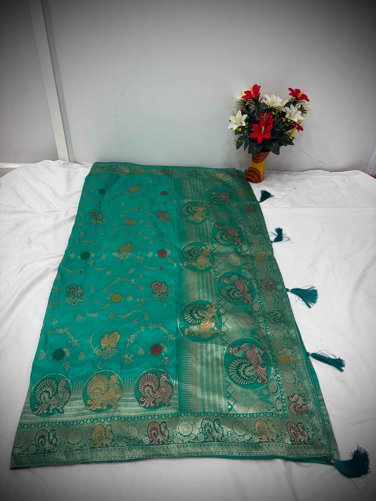 Elegant Green Satin Saree with Multicolor Zari Peacock Motifs – A Timeless Festive Attire