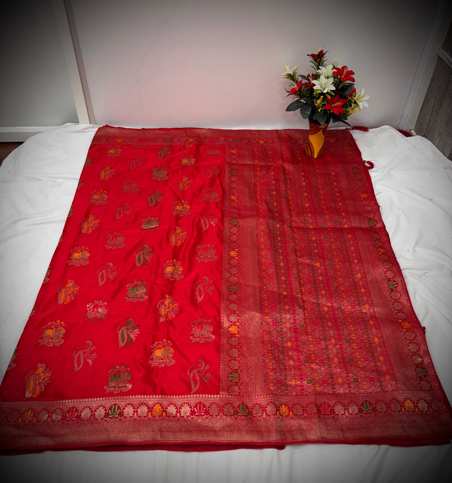 Troika Fashion – Vibrant Red Satin Saree with Multicolor Zari Weaving & Festive Motifs